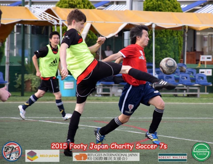 Chin takes a boot from Richie Austin - Footy Competitions Japan Charity Soccer 7s 2015