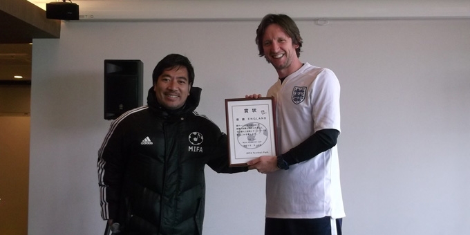 Captain Caner receiving the first place certificate from MIFA's Ken Matsui